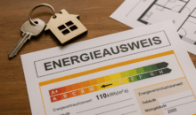 Energieausweis mit Effizienzskala liegt auf einem Holztisch neben einem Schlüssel und einem Grundriss